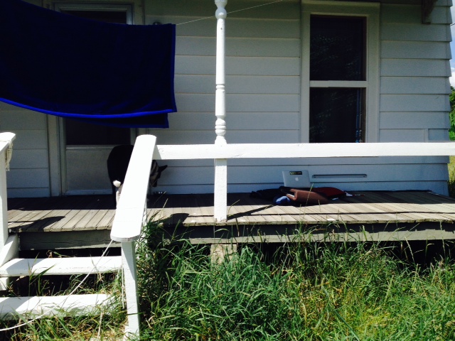 The porch office with laptop in shade.